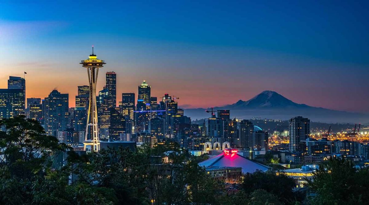 The Space Needle stands tall on the Seattle city skyline.